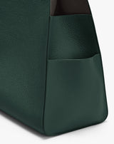 Close-up of a textured bag with a side pocket edge.