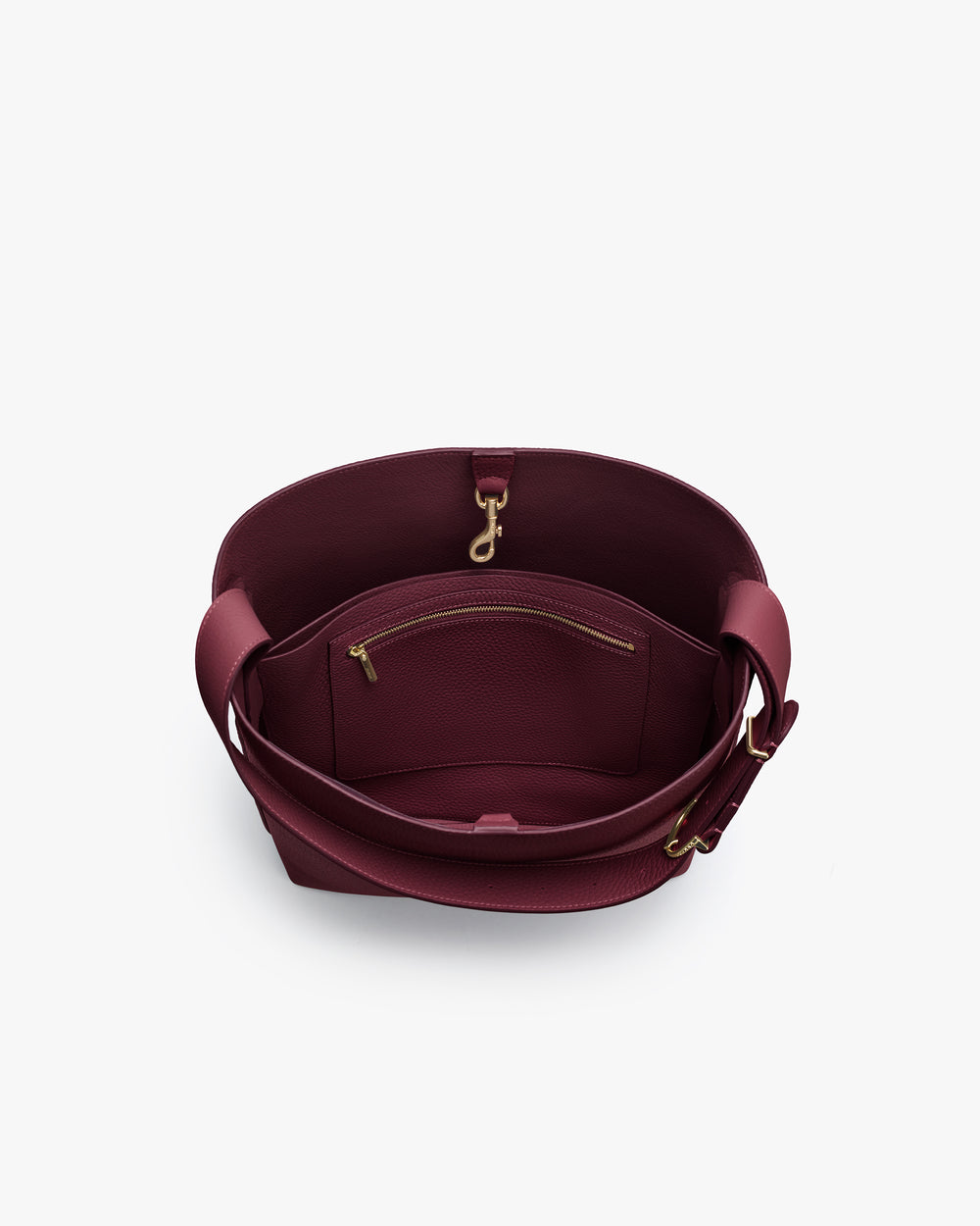 Open handbag showing inside zipper pocket and clasp.