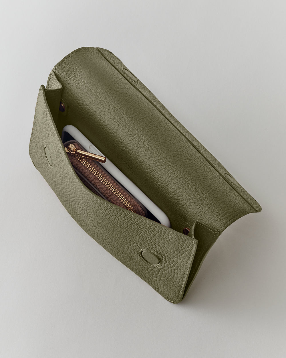 Open clutch with a zipper pouch and a smartphone inside