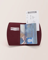 Passport and boarding pass inside an open travel wallet