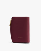 Small textured wallet with a zipper and brand name on the front