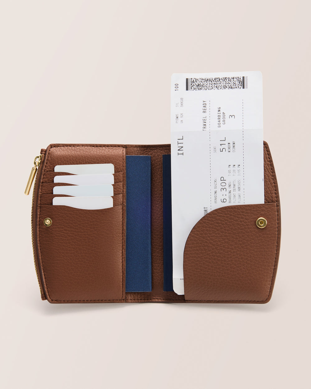 Open wallet with cards and a boarding pass inside.
