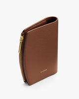 Wallet standing upright with a zipper along the edge.