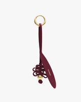 Keychain with coiled strap and round metal ring.