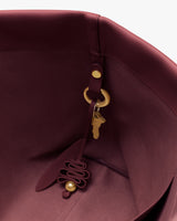 View inside a handbag with a decorative keychain attached.