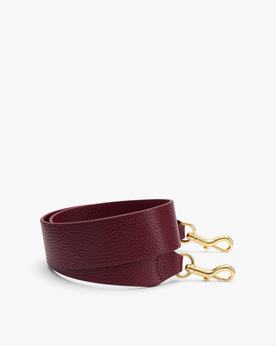 Rolled leather strap with metal hooks on each end.