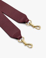 Bag strap with two metal clips at the ends.