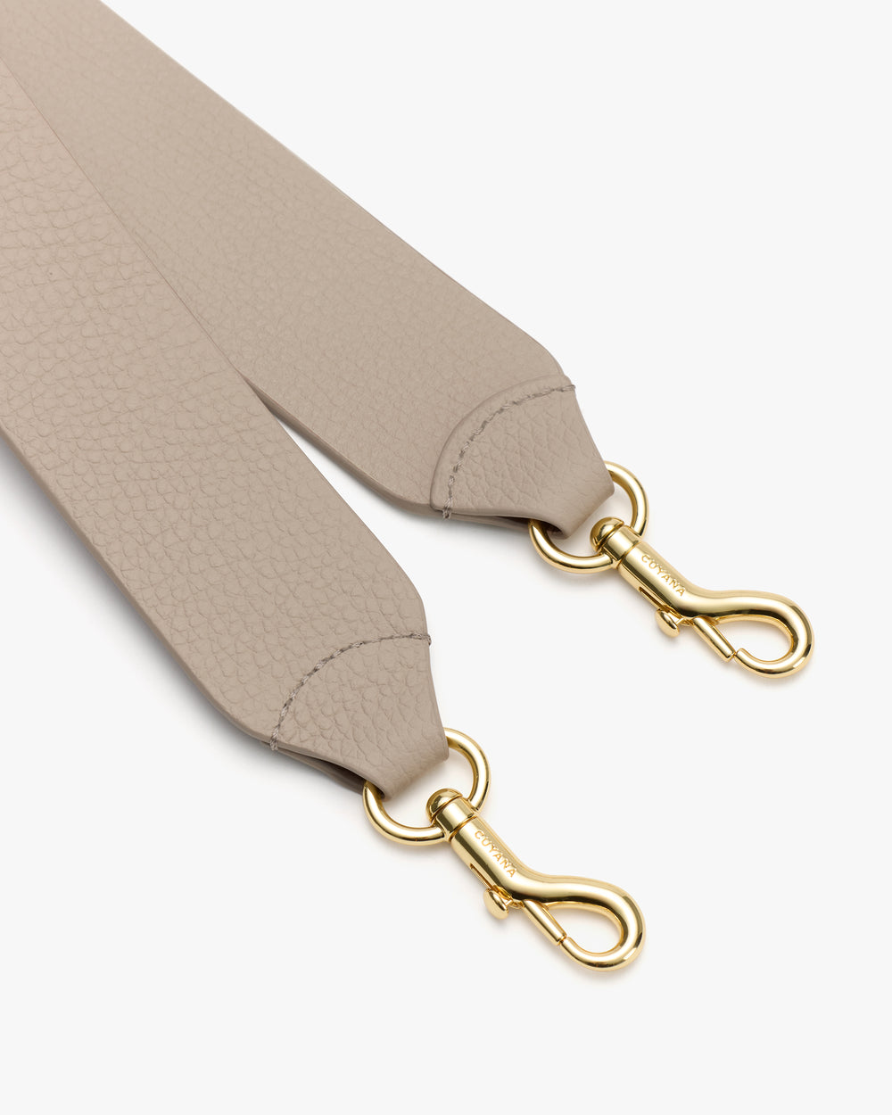 Close-up of two bag straps with metal clasps.
