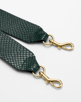 Two bag straps with metal clasps and textured surface.
