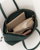 Open travel bag with a wallet, pouch, and keys inside.