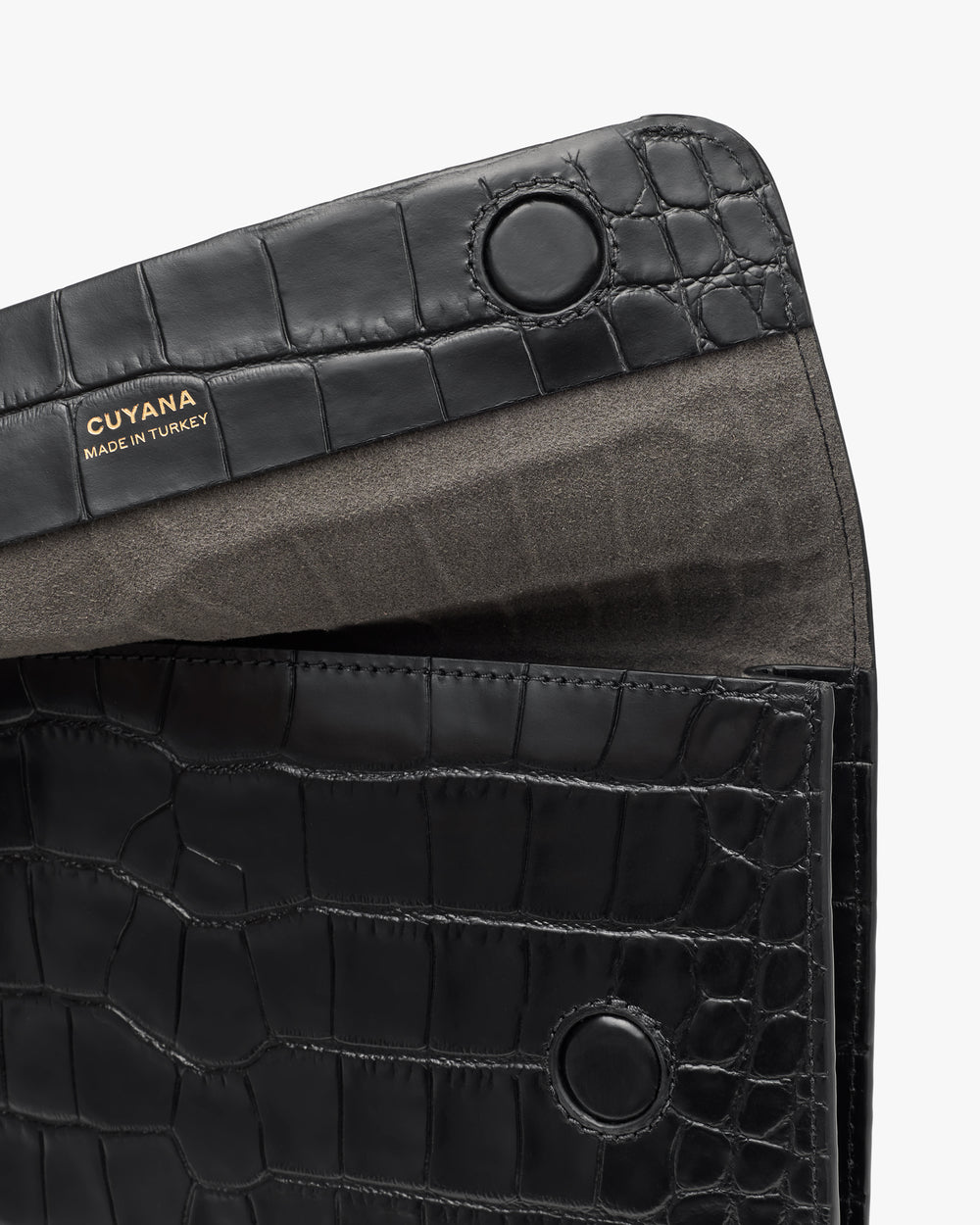 Clutch with croc-embossed leather and brand label inside.