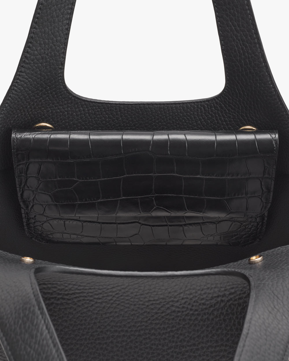 Handbag with croc-embossed leather flap and round handles.