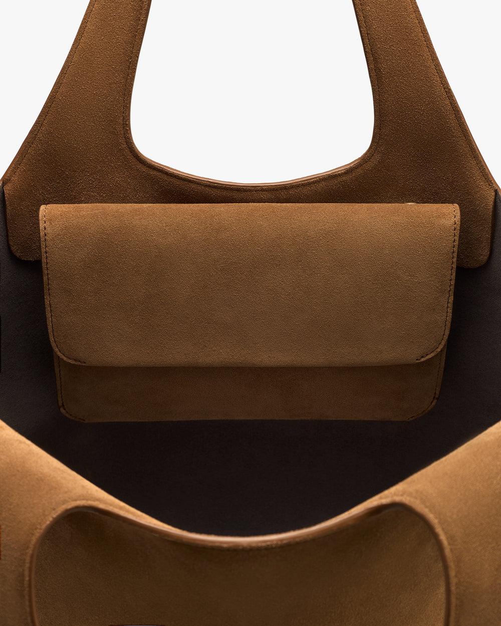 Close-up of a bag with a flap pocket and two handles.