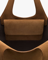 Close-up of a bag with a flap pocket and two handles.