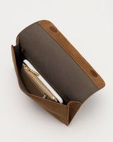 Open handbag with visible wallet and phone inside.