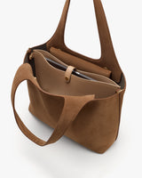 Open tote bag with handle and inner pouch visible.