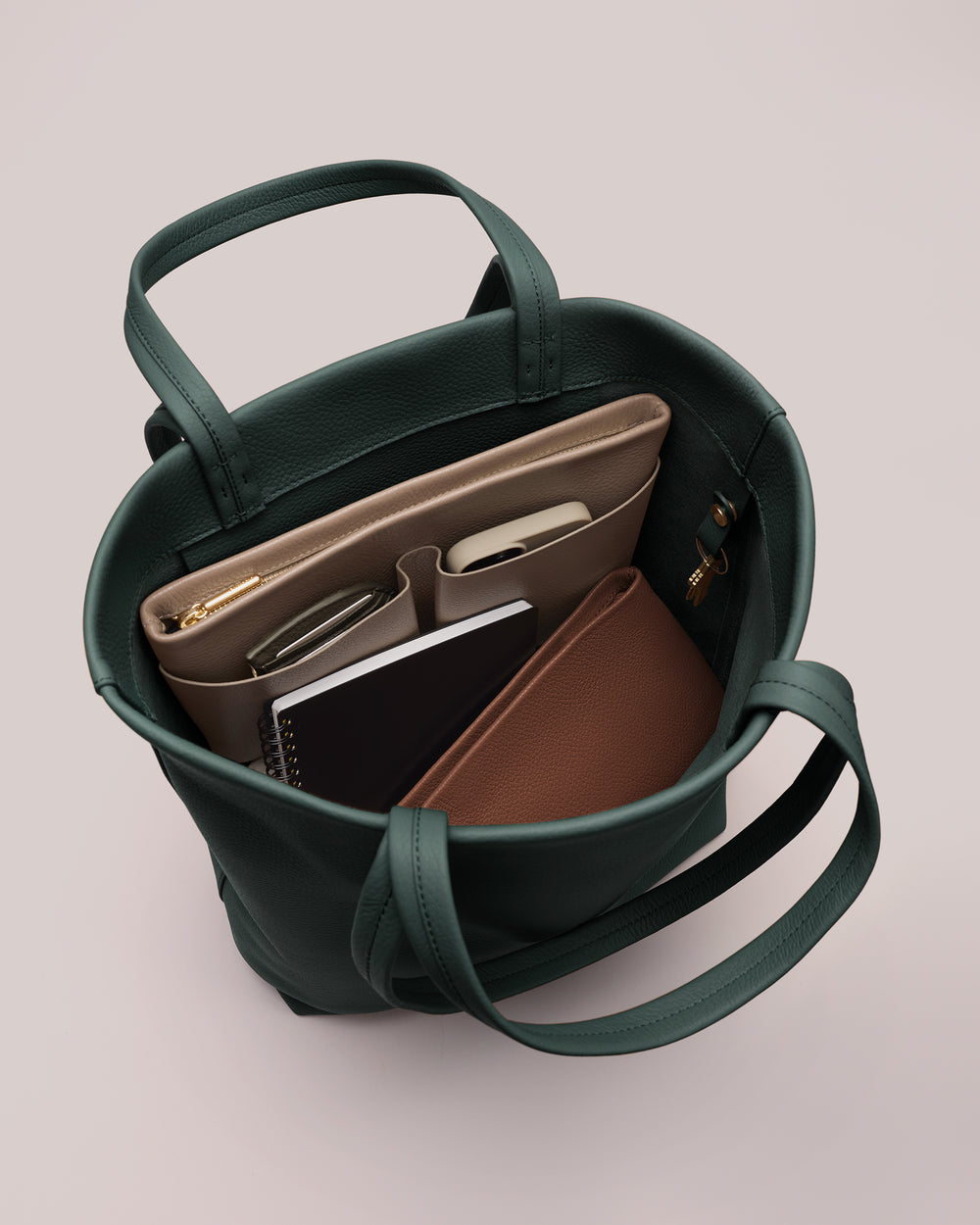 Tote bag filled with a laptop, notebook, and small organizer.