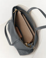 Open handbag with laptop and notebook inside
