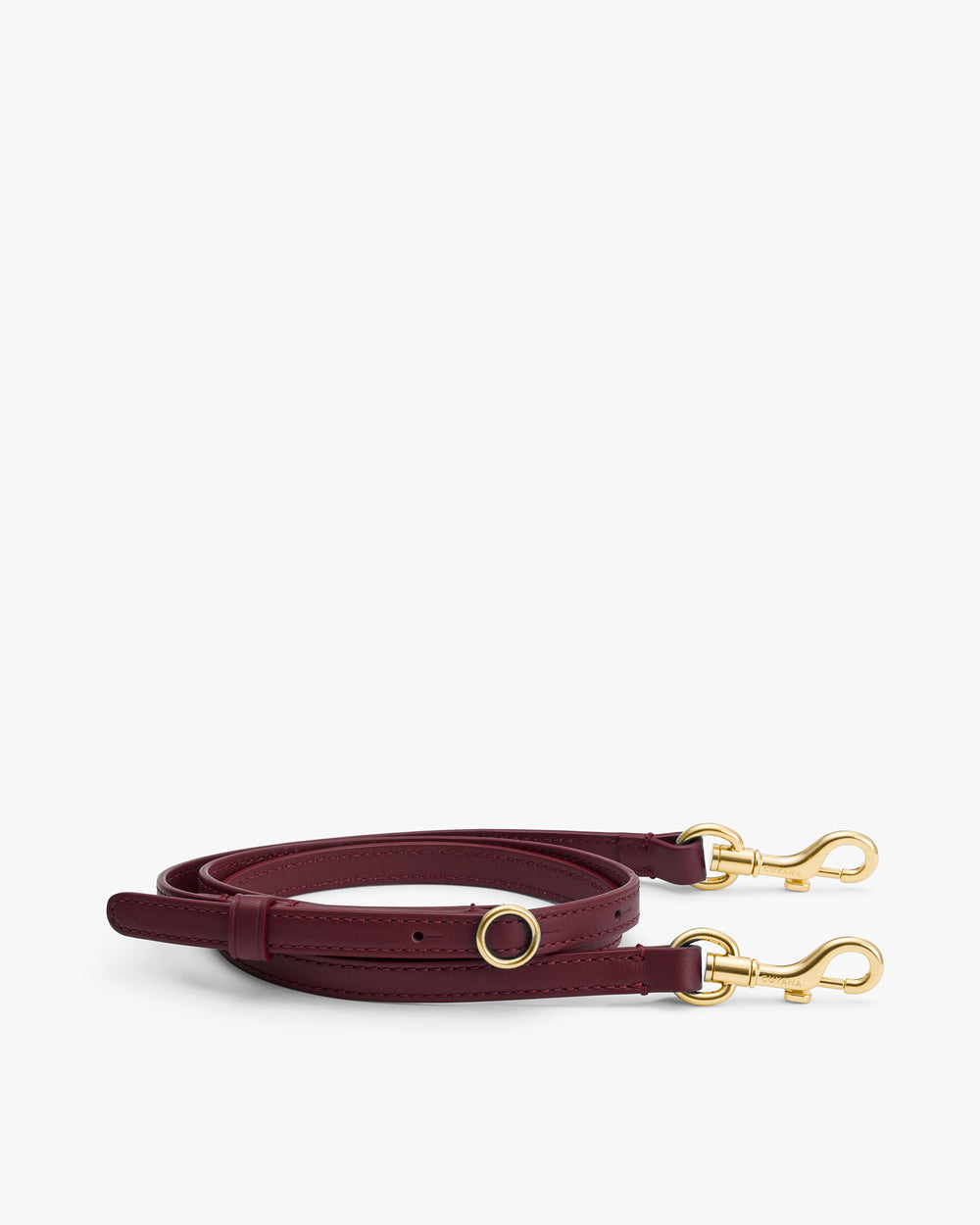 Long leather strap with gold clasps and ring details.
