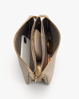 Open purse with phone, sunglasses, zippered pouch, and book inside.