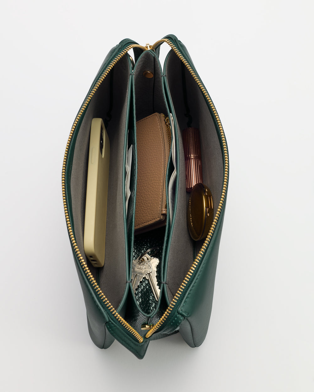 Open handbag with phone, wallet, keys, glasses, and small items inside compartments.