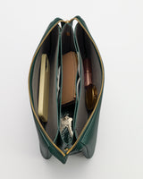 Open handbag with phone, wallet, keys, glasses, and small items inside compartments.