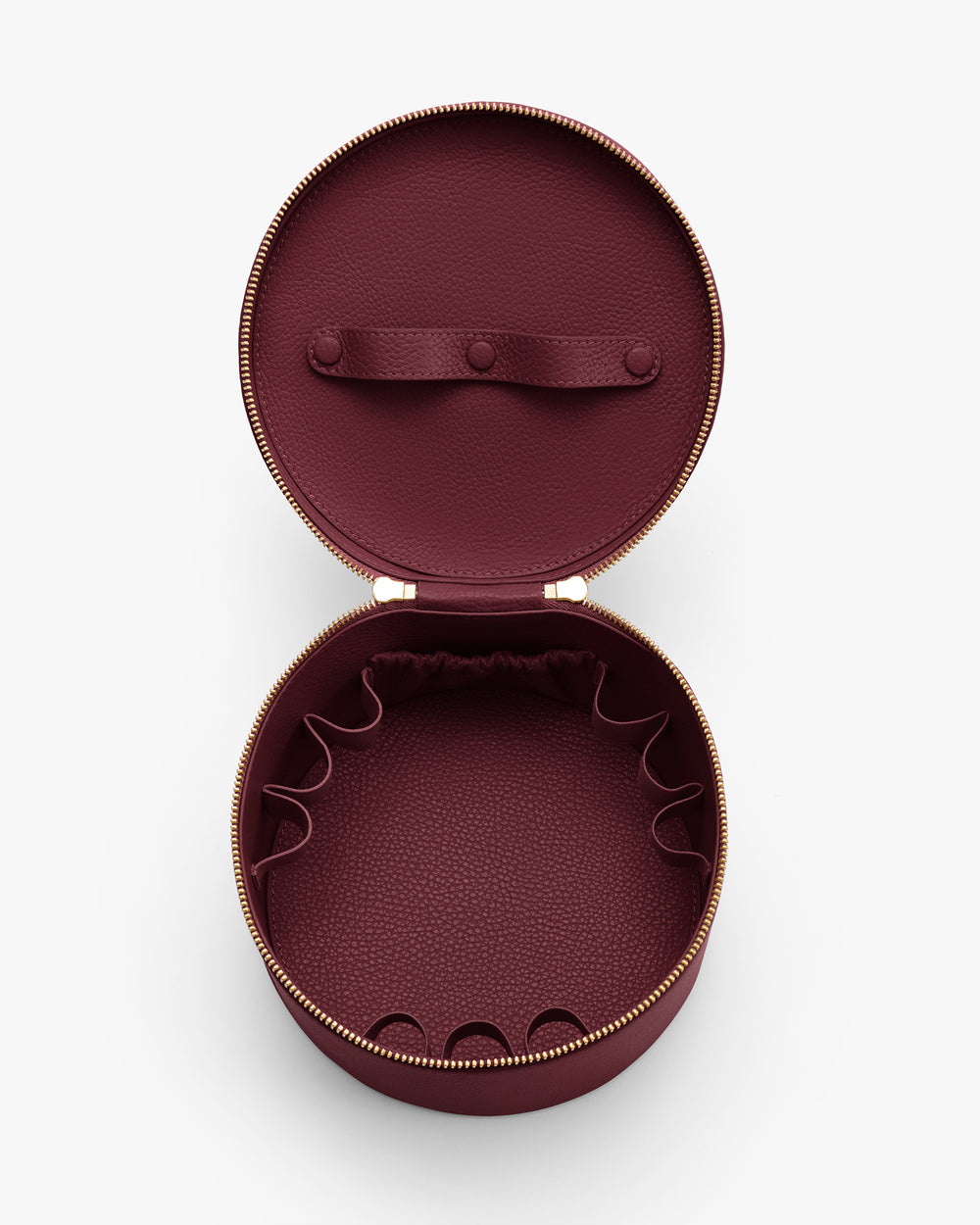 Round open jewelry case with elastic slots inside.