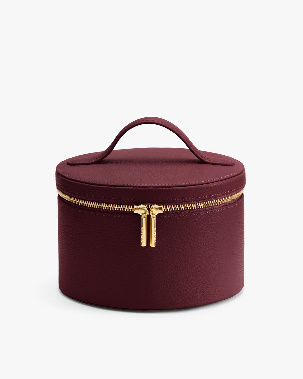 Round leather vanity case with a handle on the lid and a zipper closure.