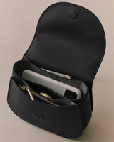 Open handbag containing a phone, wallet, and a card inside.