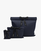 Three gift bags with ribbon bows in different sizes.