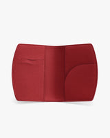 Open leather passport holder with multiple card slots.