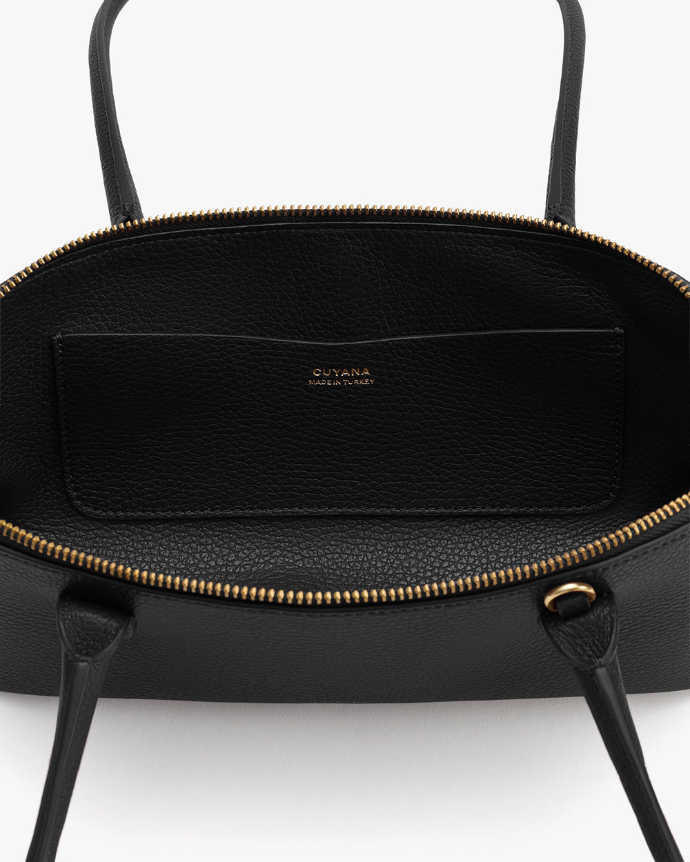 Open handbag showing interior and zip pocket.