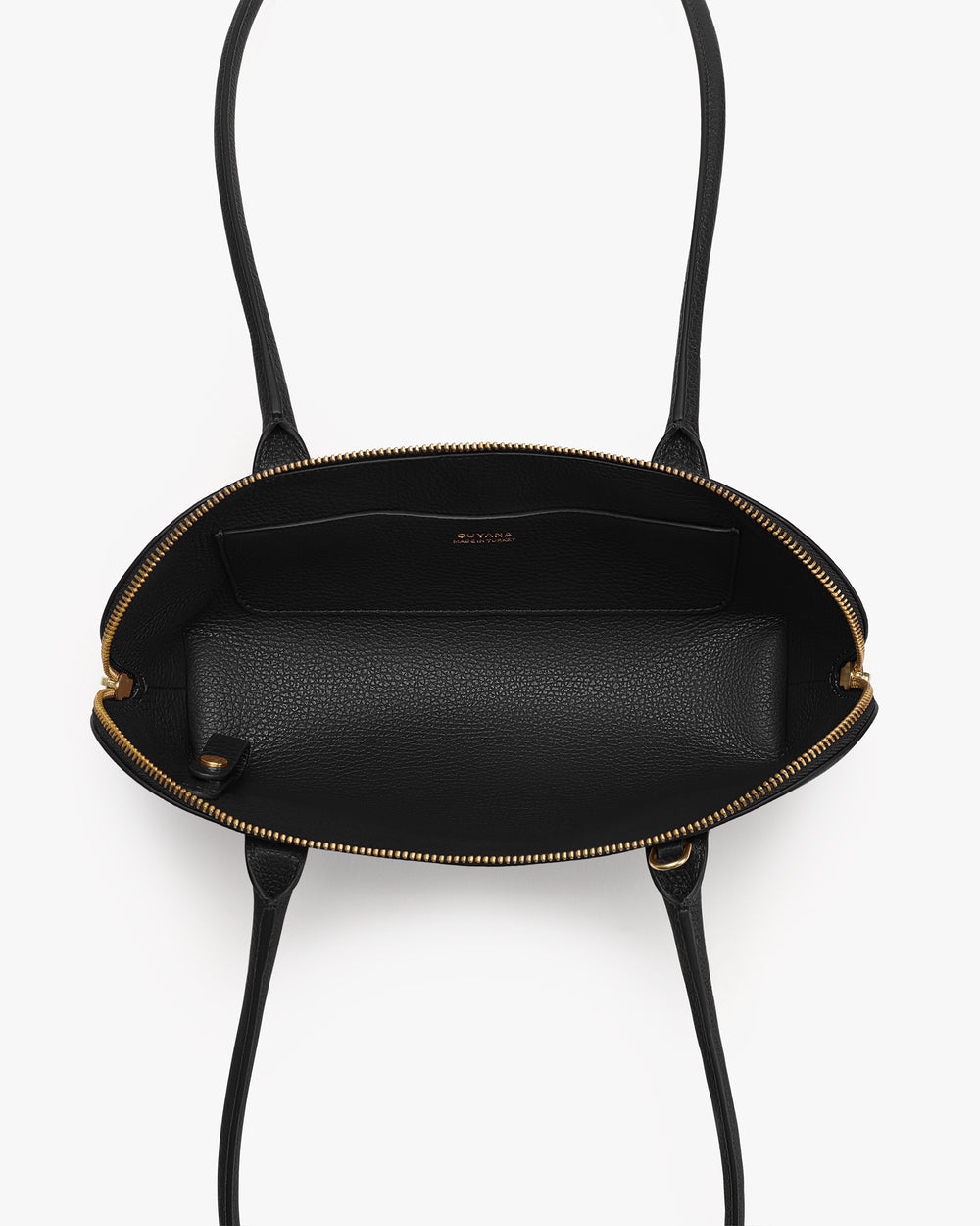 Open top view of a handbag with long straps and an interior pocket