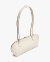 Handbag with long handles and a zippered closure.