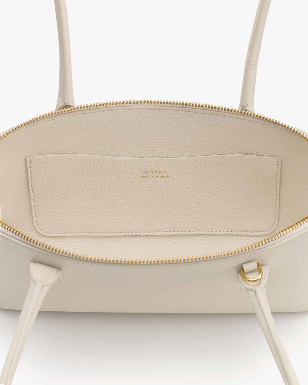 Open handbag with visible zipper and interior pocket.