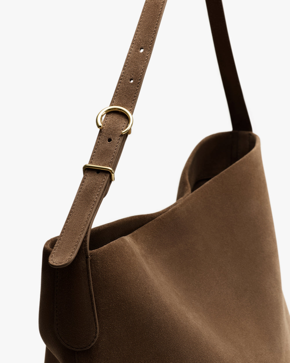Shoulder strap of a bag with metal buckle detail.
