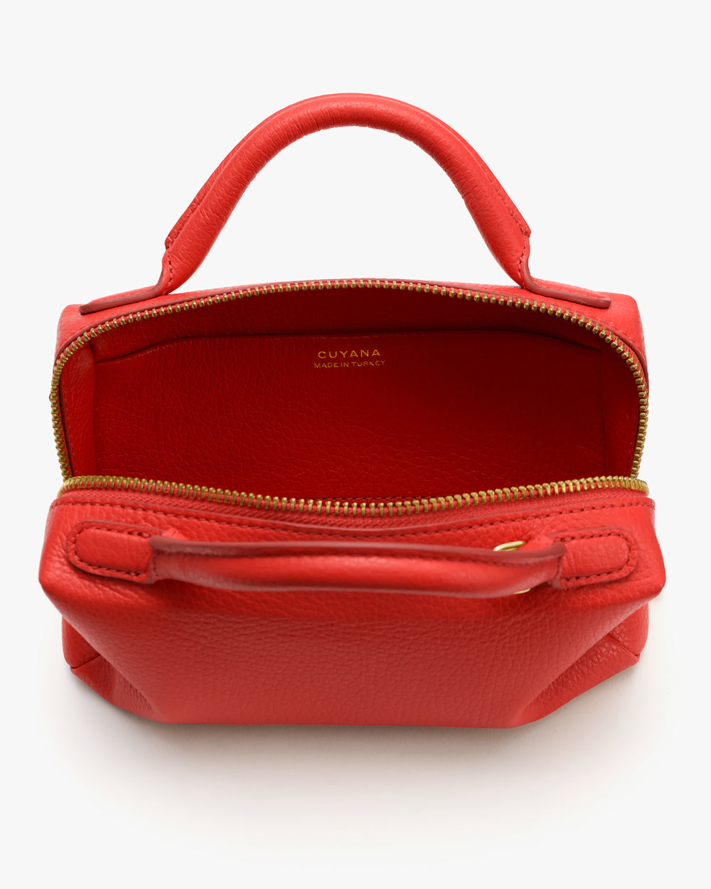 Open handbag with handle and gold zipper, viewed from top showing interior.