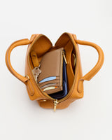 Open handbag with wallet, keys, and other items inside.