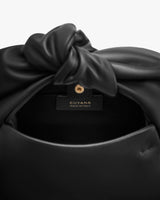 Bag with knotted detail and visible label inside