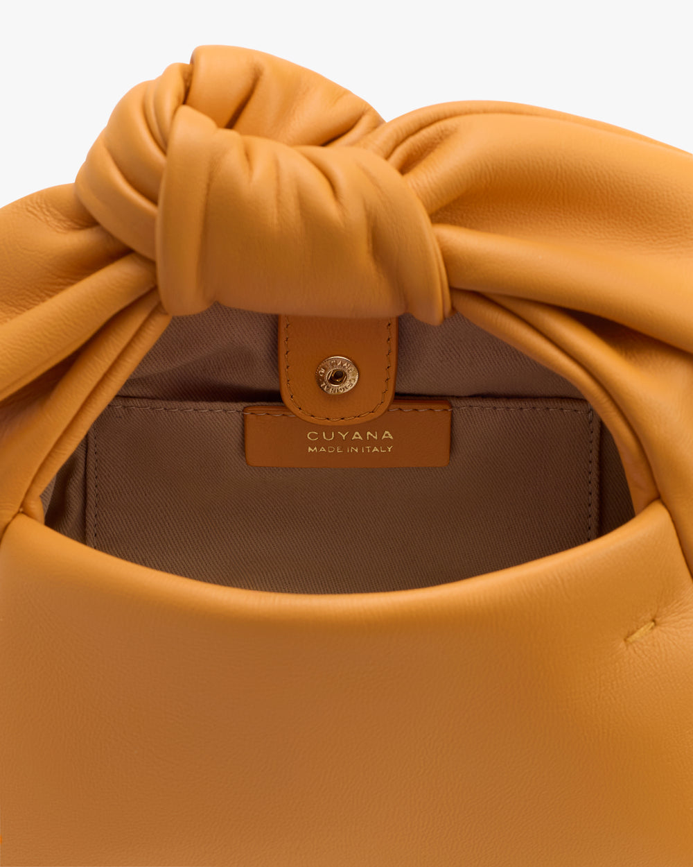 Open handbag with label inside showing the brand.
