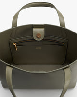Open handbag showing inside pocket with zipper and button closure.