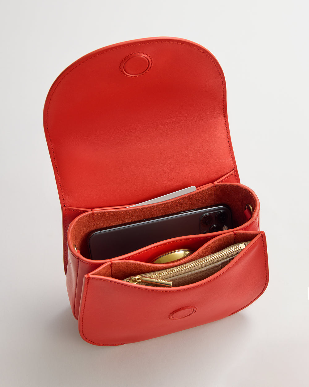 Open belt bag with phone, wallet, and pen inside