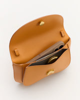 Open handbag with phone and compact inside
