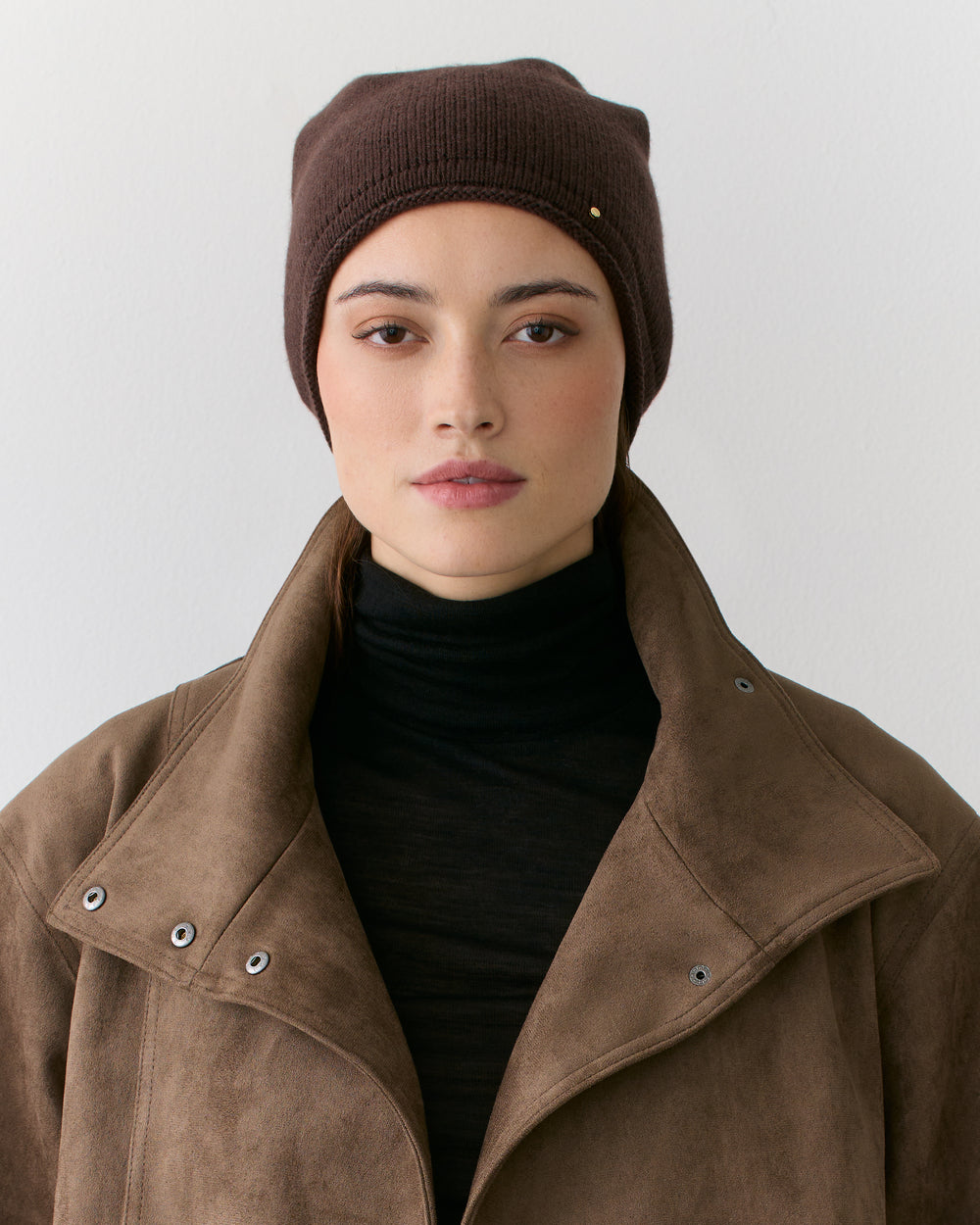 Person wearing a jacket and beanie looking forward