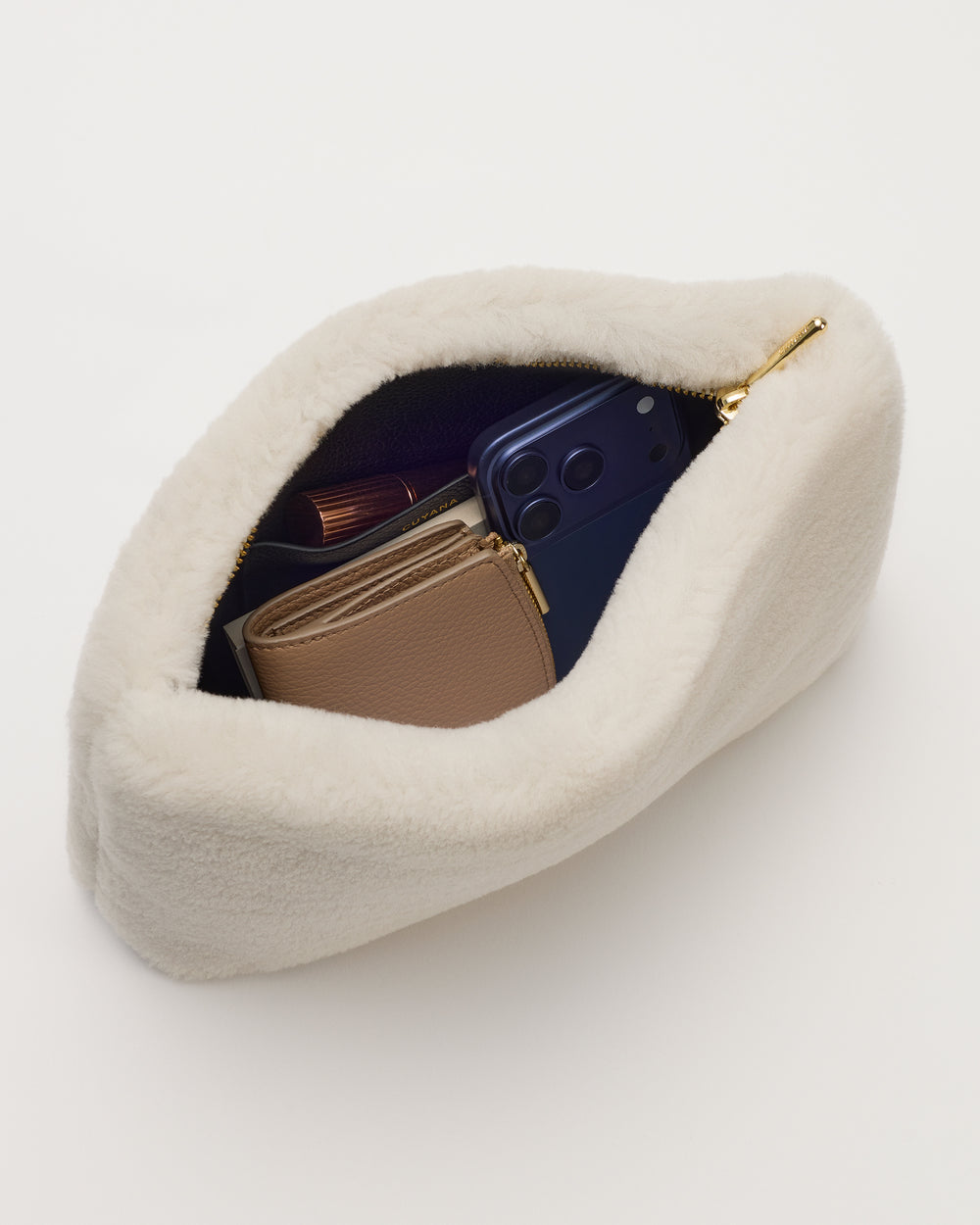 Open fluffy bag with wallet and phone inside