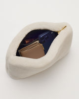 Open fluffy bag with wallet and phone inside
