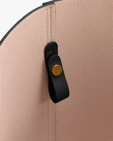 Bag interior with a black strap and gold button detail.