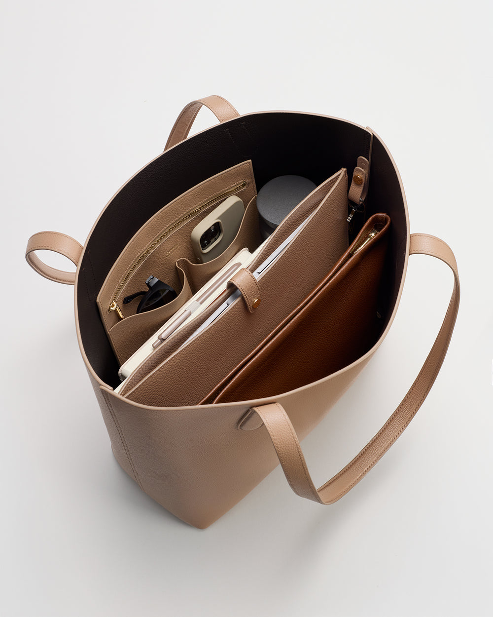 Open tote bag with organized compartments and items inside