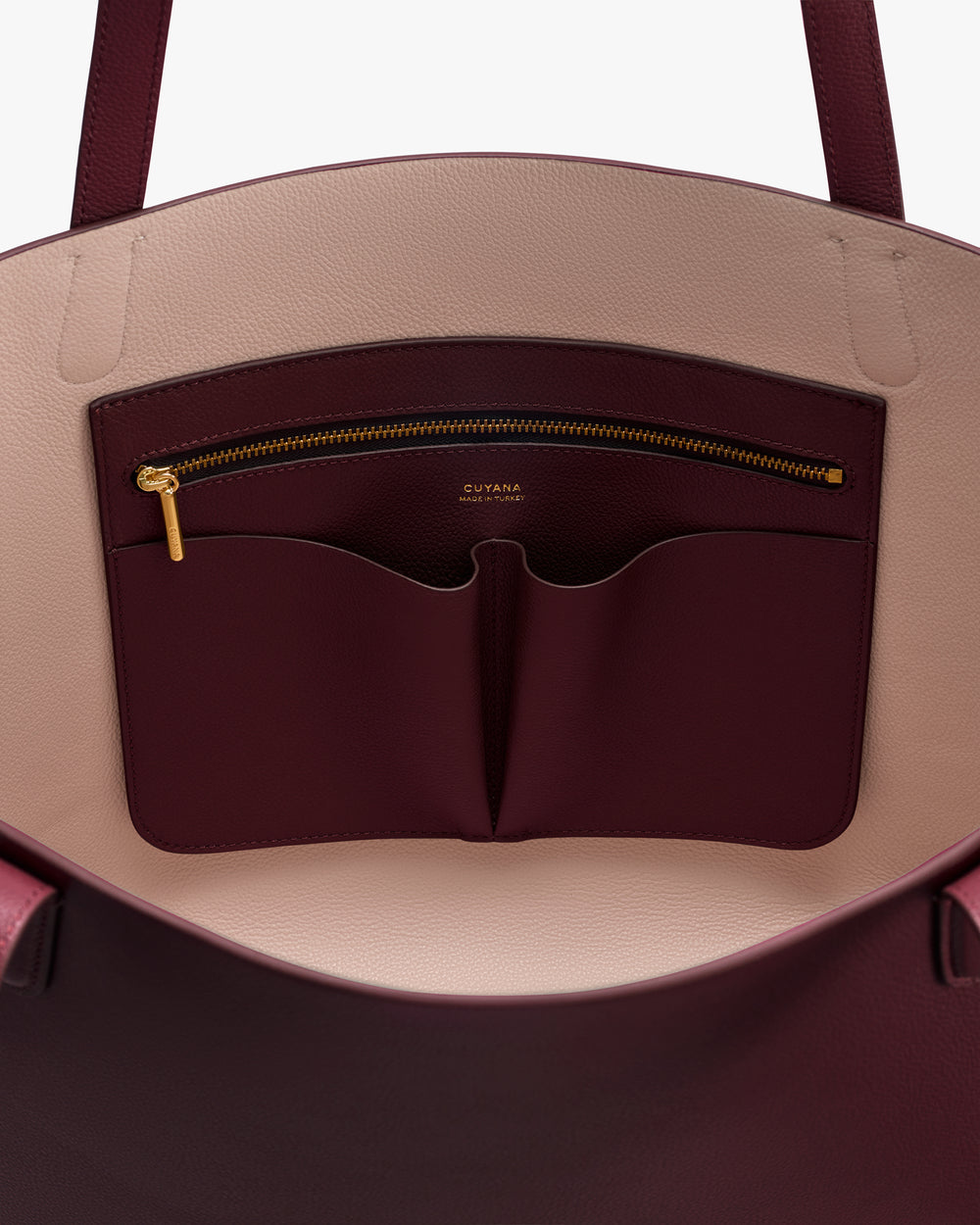 Open handbag showing interior pocket and zipper detail