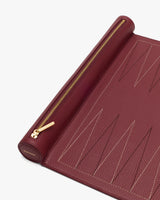 Close-up of a leather clutch with a zipper and stitched patterns